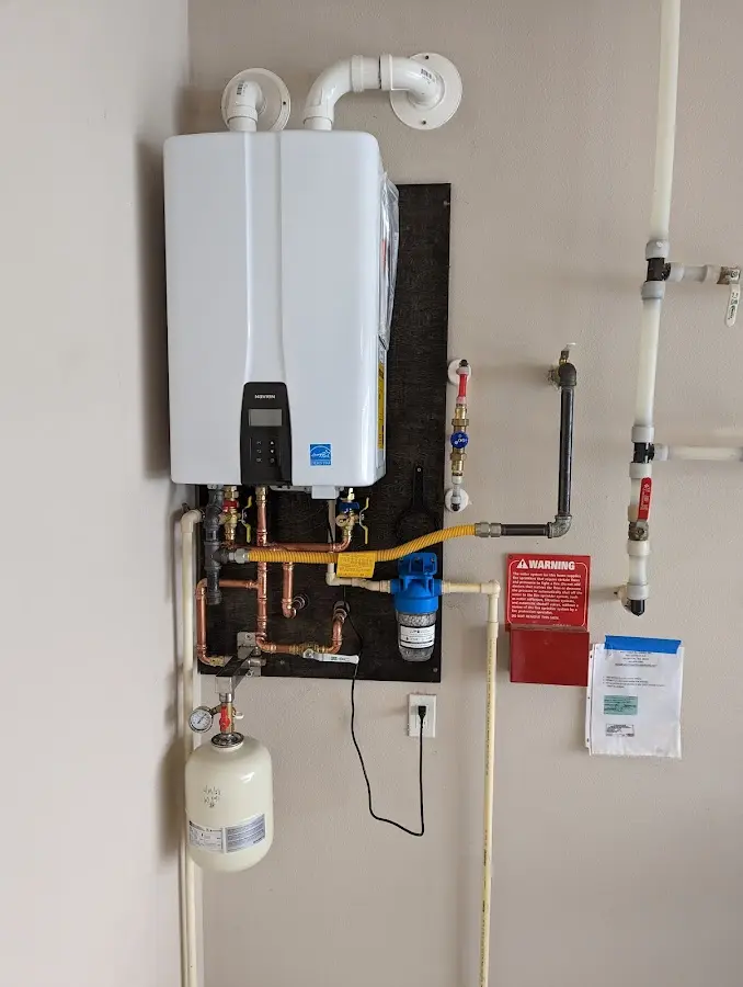 Professional plumber installing copper piping in a Warrensburg home